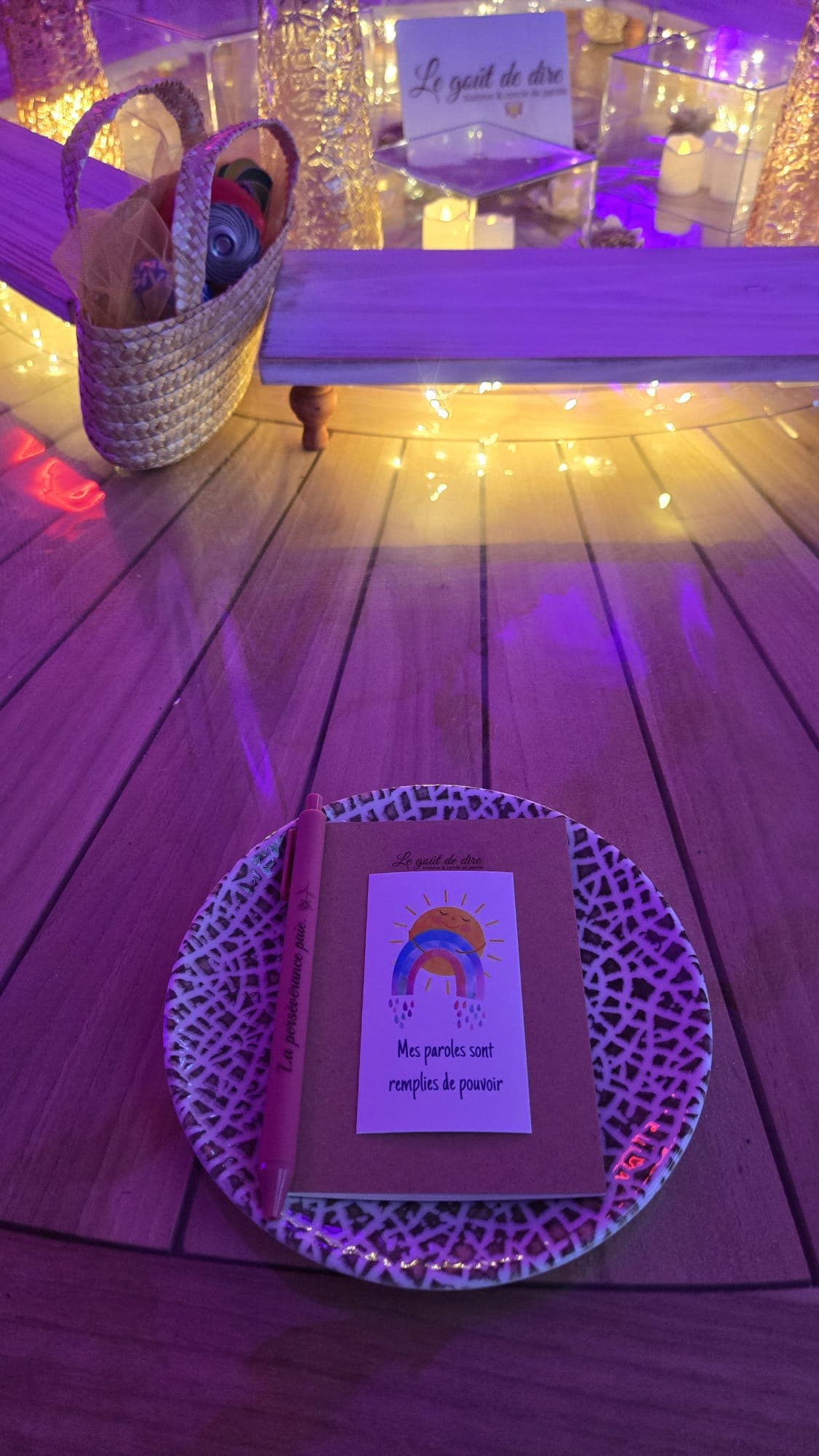 Assiette posée sur la terrasse en bois, avec une carte illustrée d'un arc-en-ciel